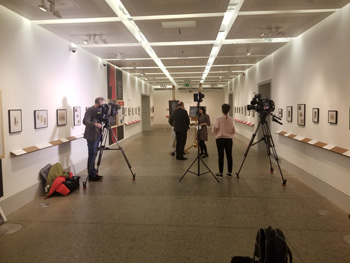 BBC Scotland filming a news piece about Brushes With War the day before its opening at the Kelvingrove Museum